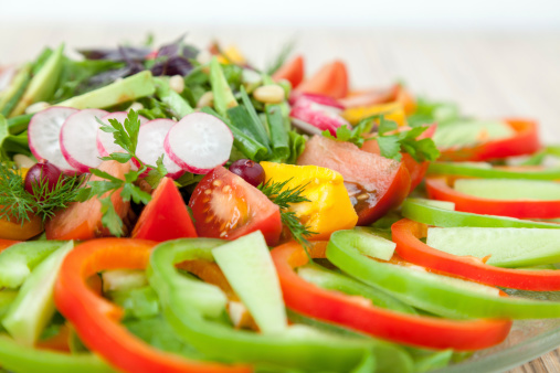 Vegetarian salad: fresh raw chopped vegetables on plate.